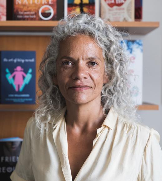 catherine johnson, standing in front of a bookshelf