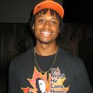 Man wearing a graphic t-shirt with an orange colored hat