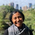 Picture of the AAS peer advisor Dorian Mendoza, smiling into the camera. She is wearing a beanie and a gray scarf. 